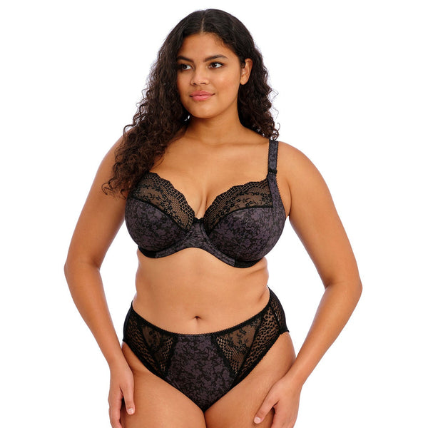 Woman wearing a black lace lingerie set on a white background