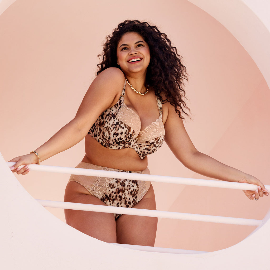 Woman wearing a leopard print bikini against a beige background