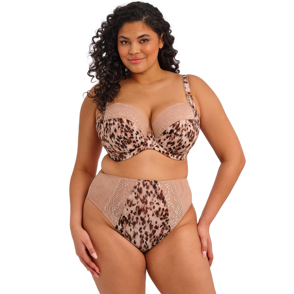 Woman wearing a leopard print lingerie set on a white background