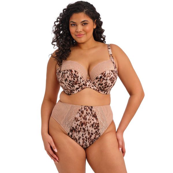 Woman wearing a leopard print lingerie set on a white background