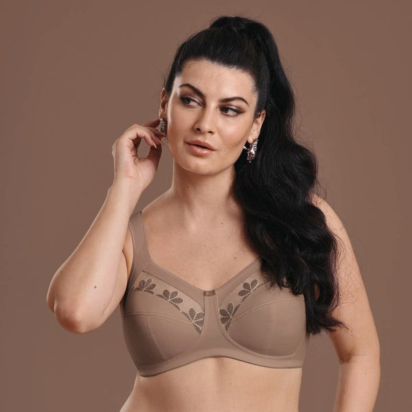 Woman wearing a brown bra and panties set against a brown background